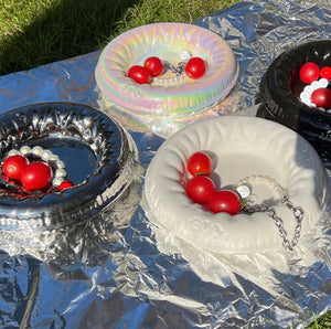 Modern Pet Bowl Collection in Assorted Colors – Sleek, reflective designs perfect for stylish pet dining. Features silver, iridescent, black, and cream bowls with vibrant red cherry decor, enhancing any pet-friendly home decor aesthetic.
