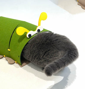 Close-up of a cat entering the green section of the felt tunnel.