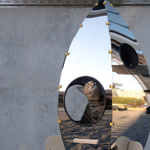 Close-up of the stainless steel exterior of the Rocket Cat Tower reflecting its surroundings.