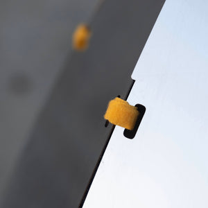 Close-up view of the secure fastening detail on the Rocket Cat Tower's sleek mirrored panel. Modern design with precise craftsmanship.