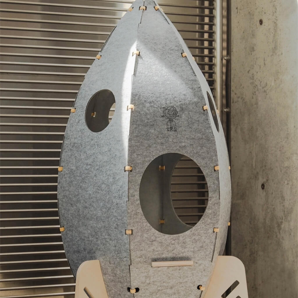 Rocket Cat Tower with concealed cat door and minimalist style in modern home.