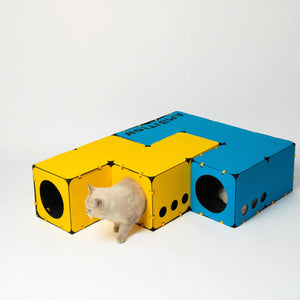 Tetris-inspired modular cat furniture featuring yellow and blue stackable hideout blocks. Perfect for interactive play, climbing, and cozy resting spots.