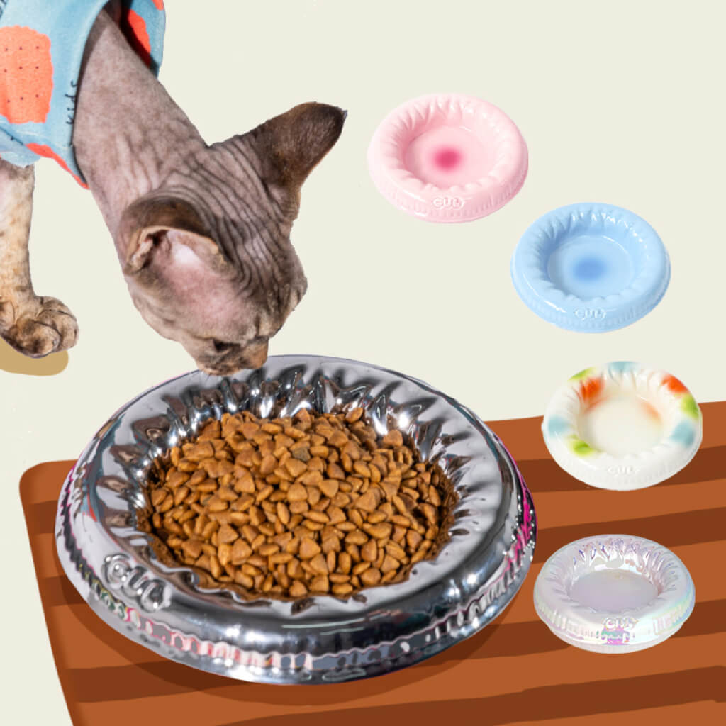 Cat Eating from a Metallic Silver Pet Bowl – A stylish buoy-inspired multi-use pet bowl with a mirror-finish ceramic surface, ideal for modern pet owners.