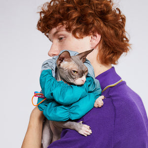 Close-up of a grey and bluish-green pet e-collar with a gradient fabric, designed to prevent post-surgery licking and scratching.