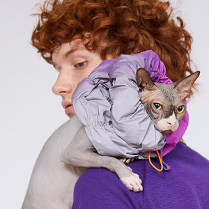 Close-up of a cat wearing the Fashion-Function Pet E-Collar in Magenta and Dark Purple, resting on the owner's shoulder.