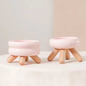 Gulu Ceramic Pet Bowl in Cherry Pink with wooden legs, perfect for cats.