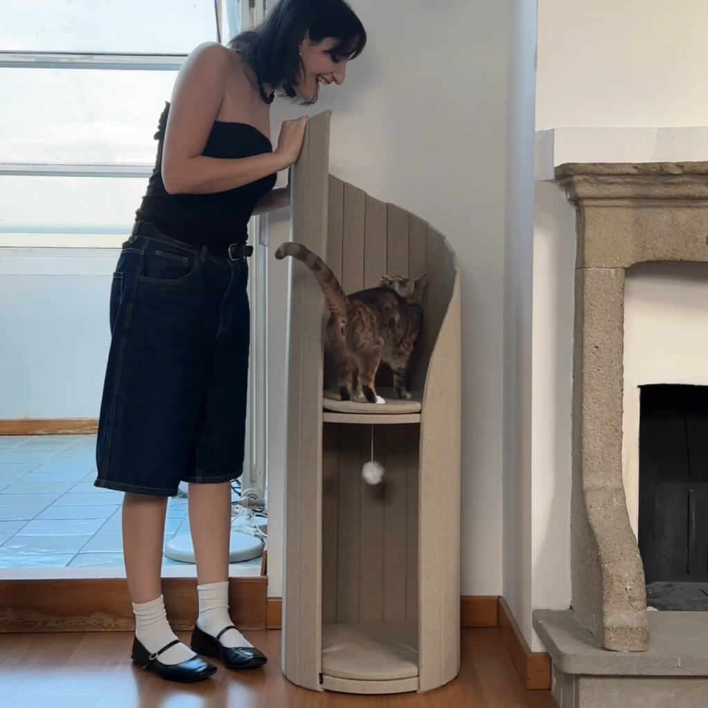 Woman interacting with cat on Meoof Time Travel Tower Cat Tree in oatmeal color – modern vertical cat furniture for play and rest.