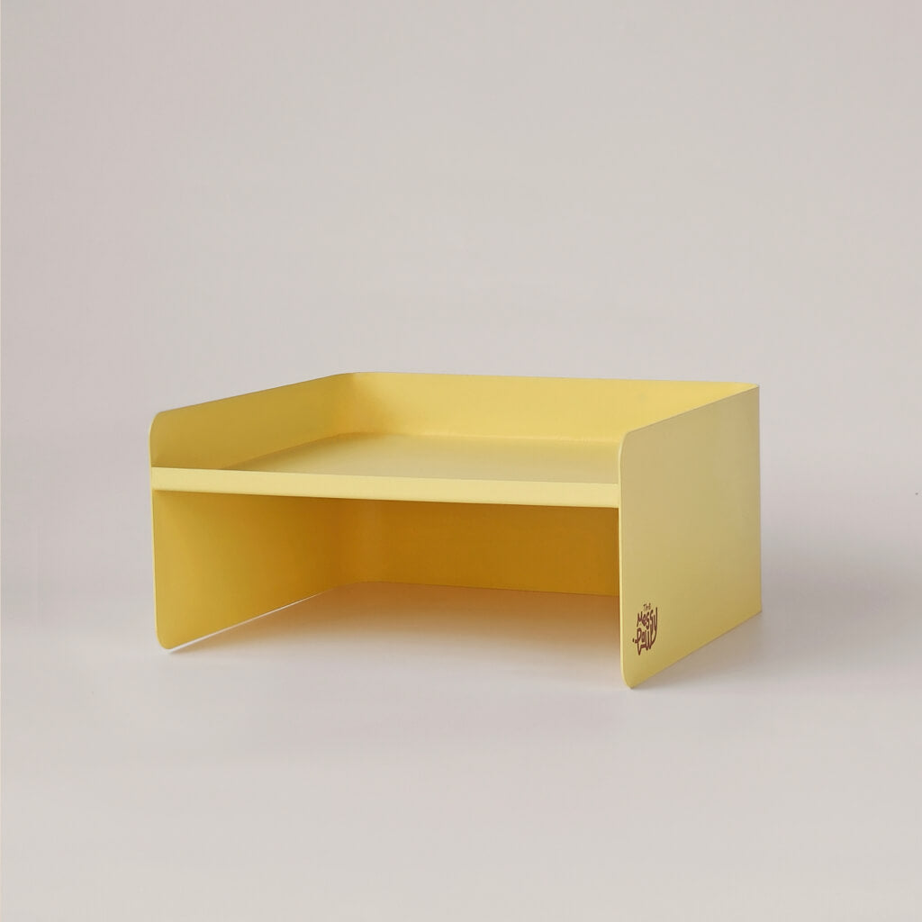 Yellow metal pet bowl stand with modern dual-height structure – stylish elevated feeder for small pets.