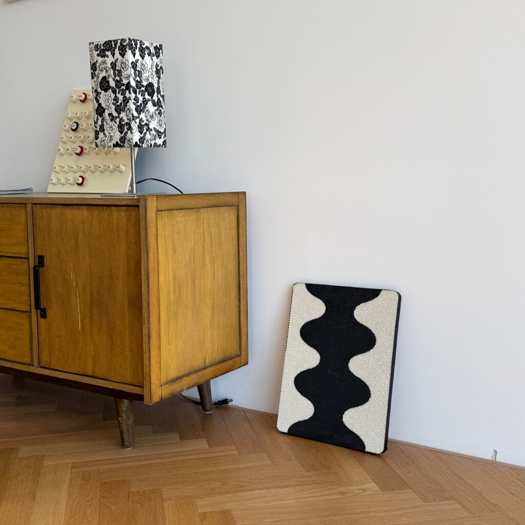 Coral Cat Scratching Pad placed against wall beside mid-century wooden cabinet