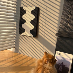 Coral Cat Scratching Pad mounted on wall in sunlight with fluffy orange cat nearby