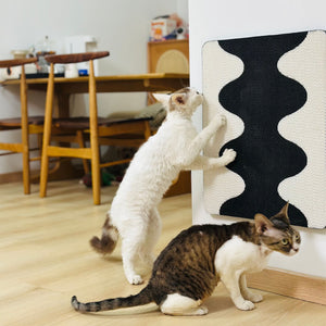 Two cats playing with wall-mounted Coral Cat Scratching Pad – interactive scratch board for multi-cat homes.