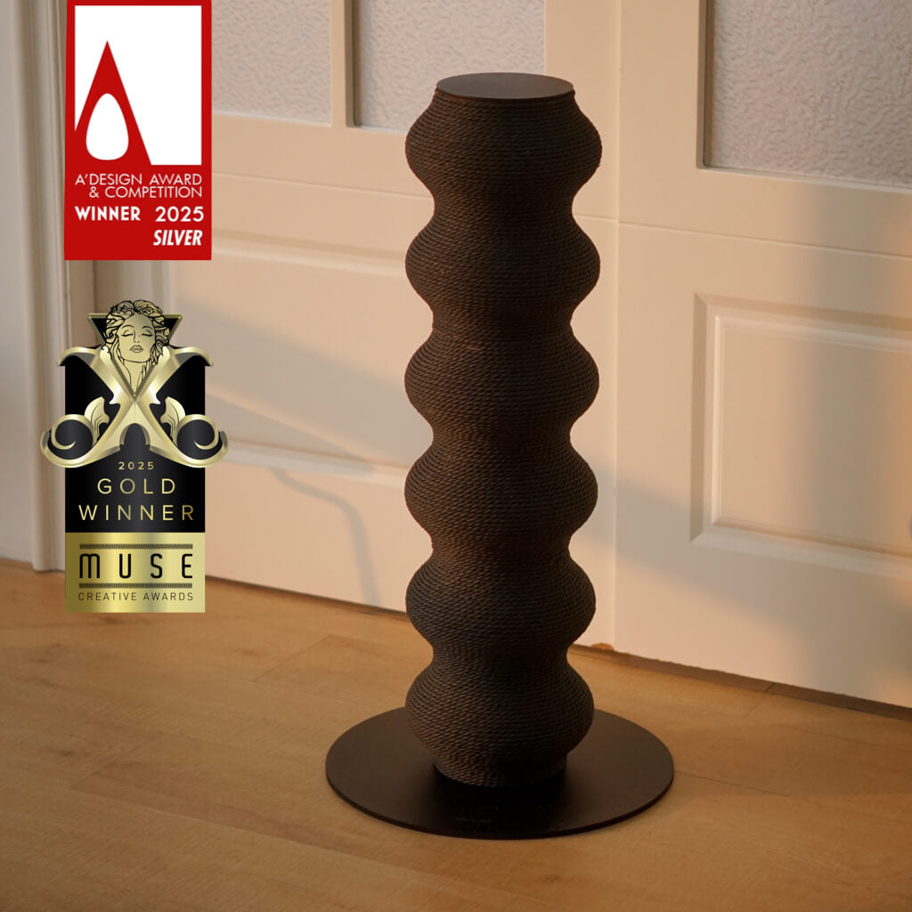 Award-winning minimalist wavy cat scratching post in matte black. Coral Scratcher by Momoland, winner of 2025 A'Design Silver & MUSE Gold Awards. Modern sculptural cat furniture.