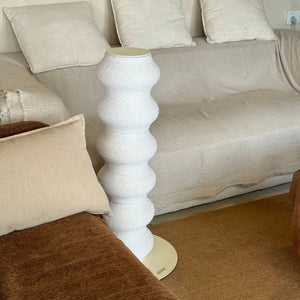 Minimalist white wavy cat scratching post – Coral Scratcher by Pewos, modern vertical scratcher in cozy neutral-toned living room.