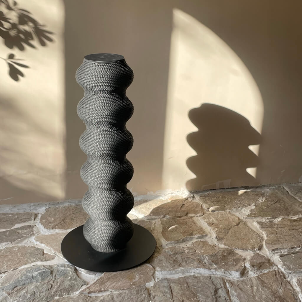Sunlight casting shadows on the sleek Wavy Scratching Post, showcasing its elegant curves.