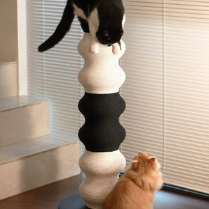 Two cats playing around a dual-tone Minimalist Wavy Scratching Post, featuring a sleek black and white design that doubles as stylish home decor.