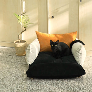 Black cat relaxing on the Pure Cotton Corduroy Pet Couch with elegant design in natural lighting.