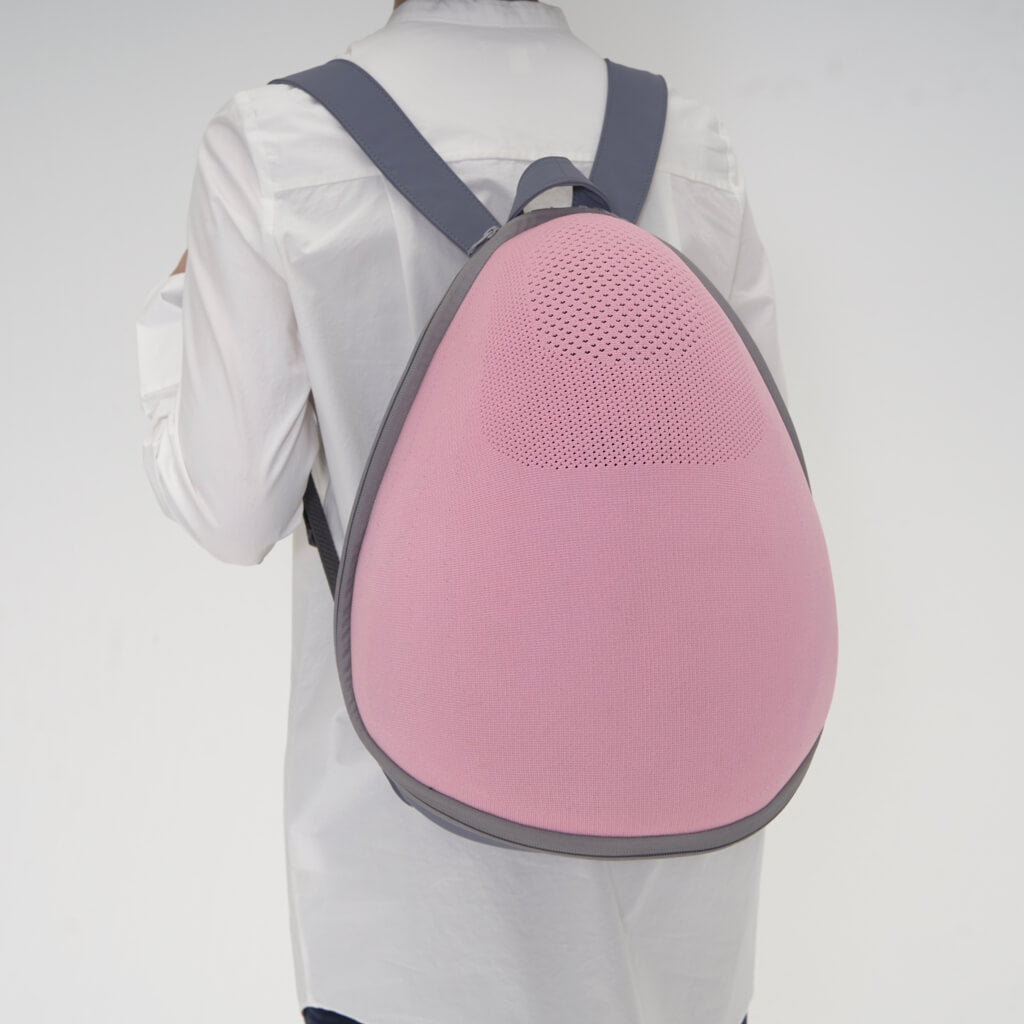 Rear view of a person wearing the Extra-light Cat Travel Backpack in Pink+Grey, illustrating the ergonomic fit.