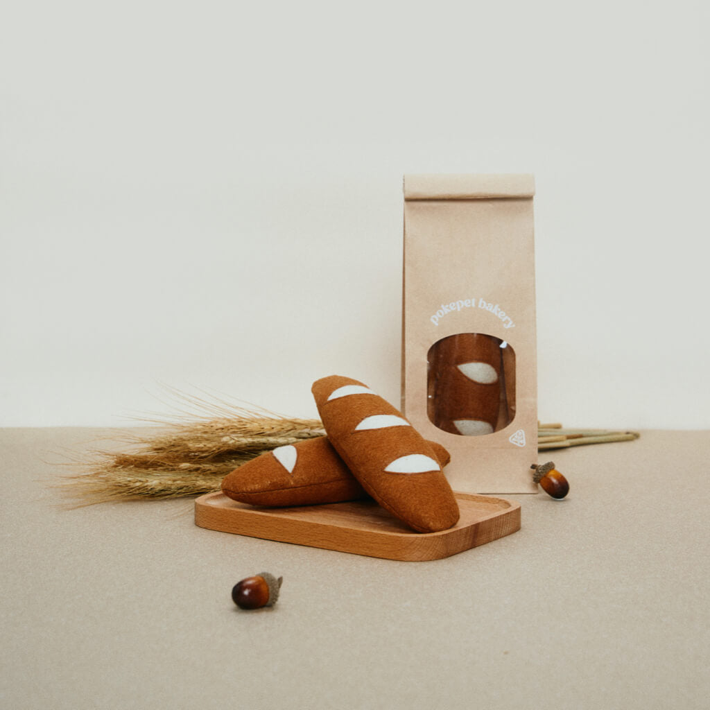Baguette cat toy set displayed with natural elements.