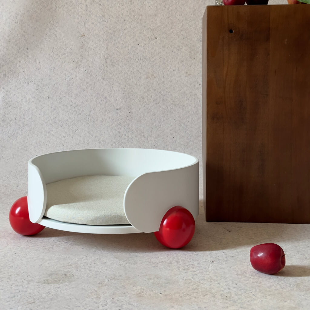 White HugMe Pine Wood Pet Lounger with red ball accents – A minimalist and modern cat bed designed for luxury comfort and interior harmony.