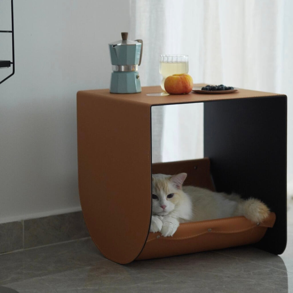 Multi-functional cat cave and side table in premium saddle leather, designed for modern home decor and cozy feline relaxation.
