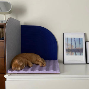 Cat Sleeping on Scratcher: Orange cat peacefully napping on the Velvet Blue Purrre 3-Dimensional Design Cat Scratcher, which doubles as a stylish corner piece for your home.