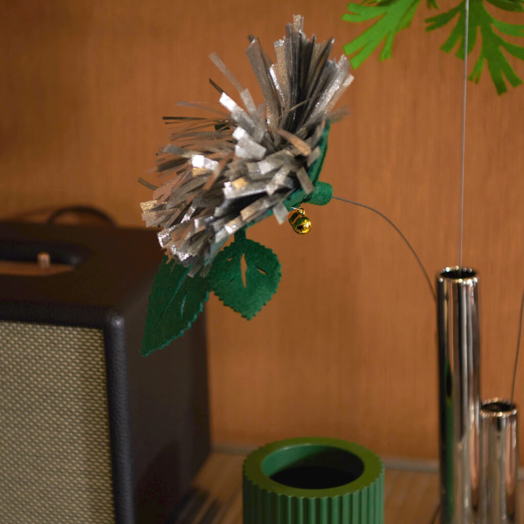 Close-up of the Purrre Enchanting Cat Teaser - Sliver Grass, showcasing the intricate felt design and golden bells.