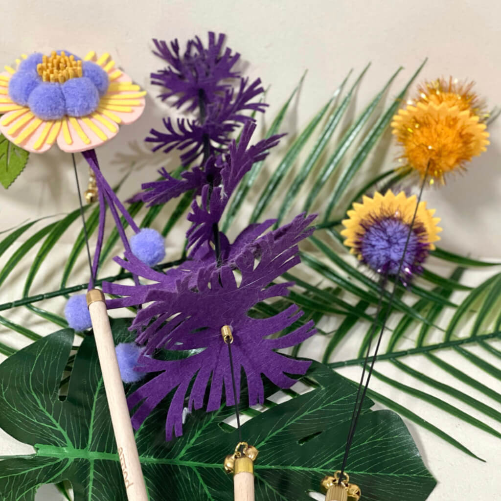 Close-up of the purple and green felt umbrella-shaped cat teaser with a modern touch.