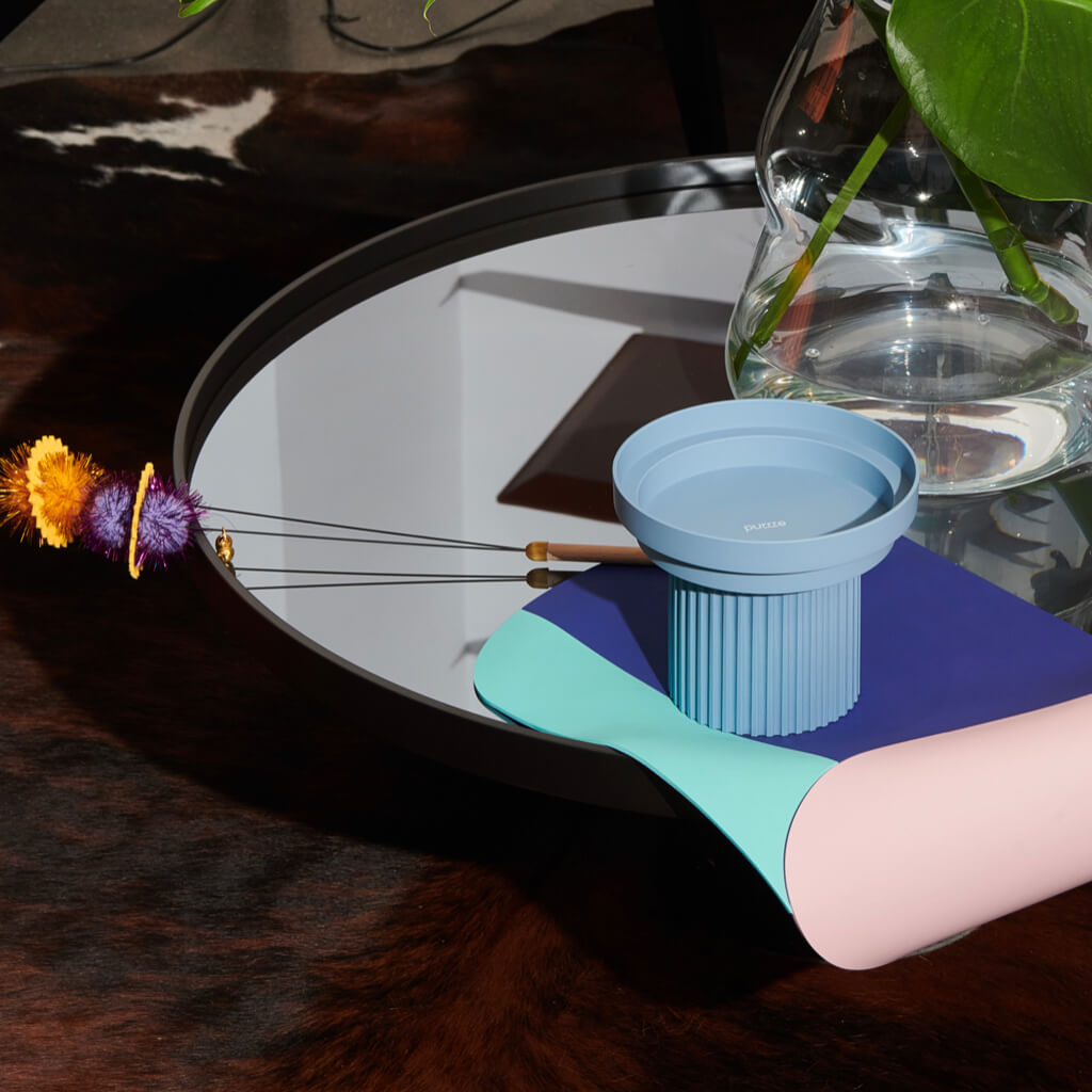 Purrre Teeth Party Pet Bowl - Airy Blue on a modern table with pet accessories.