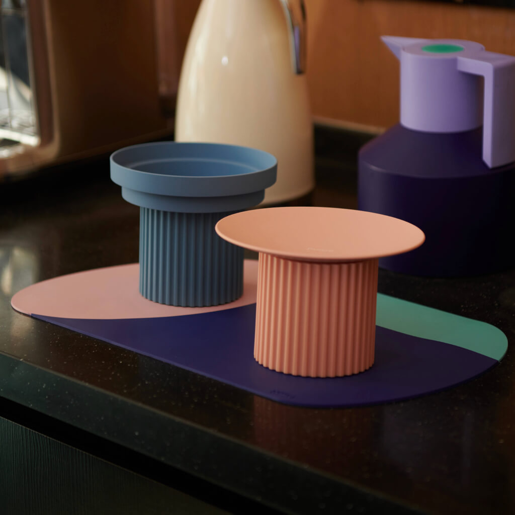 Purrre Blue and coral Teeth Party Pet Bowls displayed on a chic countertop, highlighting their modern design and color contrast.