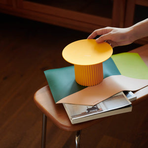 Close-up of Purrre Teeth Party Pet Bowl in Sunset Yellow placed on a wooden table.
