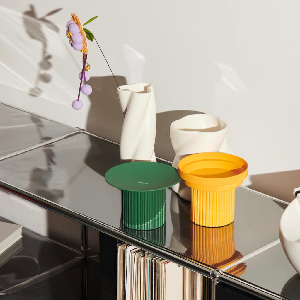 Modern Purrre Teeth Party Pet Bowl in Sunset Yellow and Green, sitting on a sleek countertop.