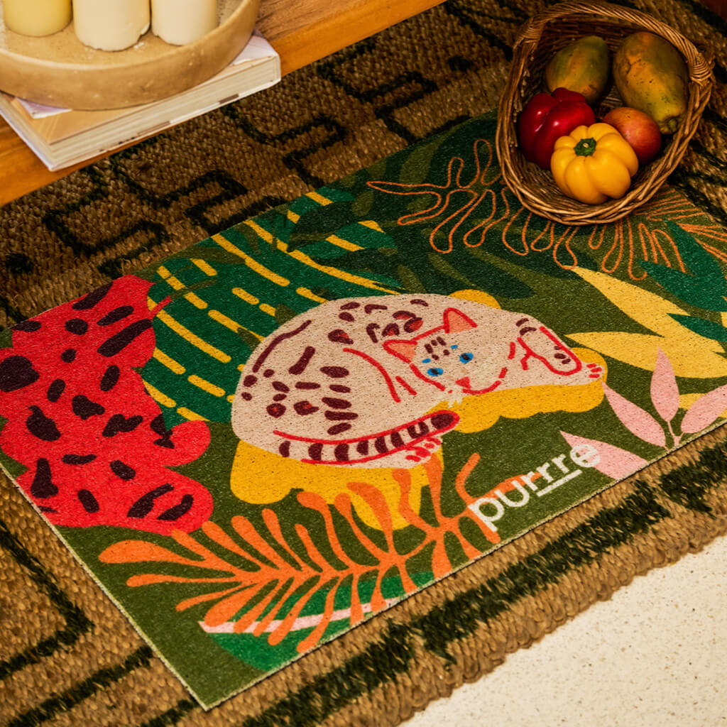 Purrre Tropical Jungle Cat Mat placed near entryway with fruit basket – functional and artistic mat for pets and humans.