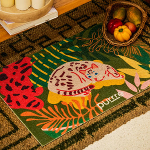 Purrre Tropical Jungle Cat Mat placed near entryway with fruit basket – functional and artistic mat for pets and humans.