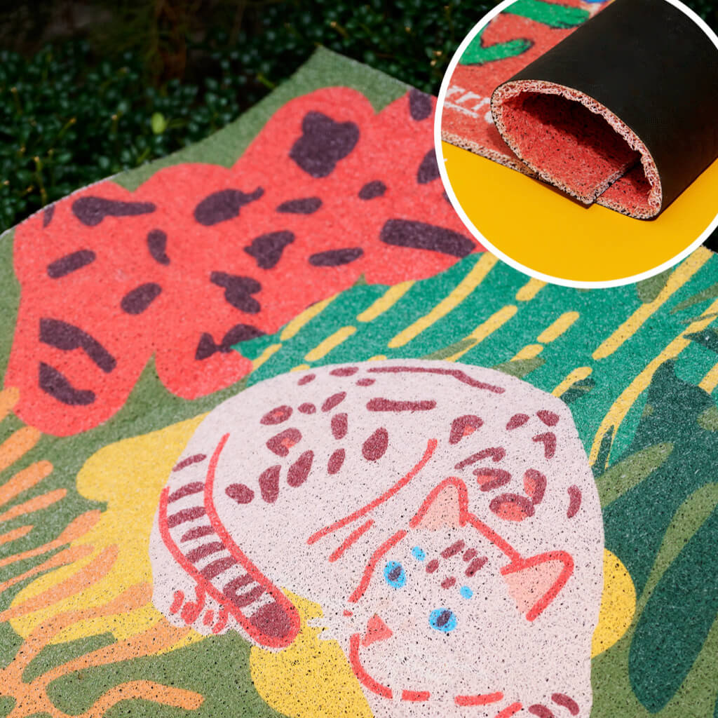 Close-up detail showing dual-layer structure of the Purrre cat mat with non-slip rubber backing.