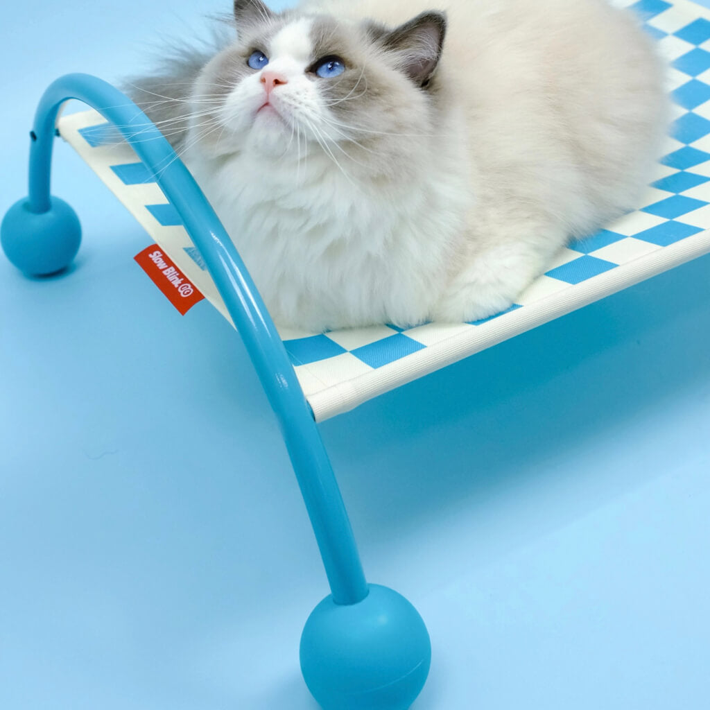 Blue Memphis Maze cat hammock with a serene white and blue cat lying comfortably.