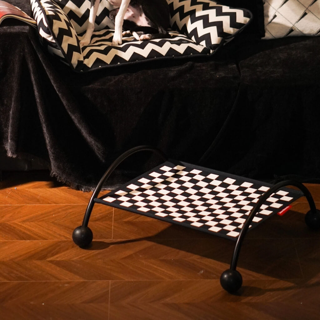 Modern pet hammock featuring a black and white geometric design in a stylish indoor setting.