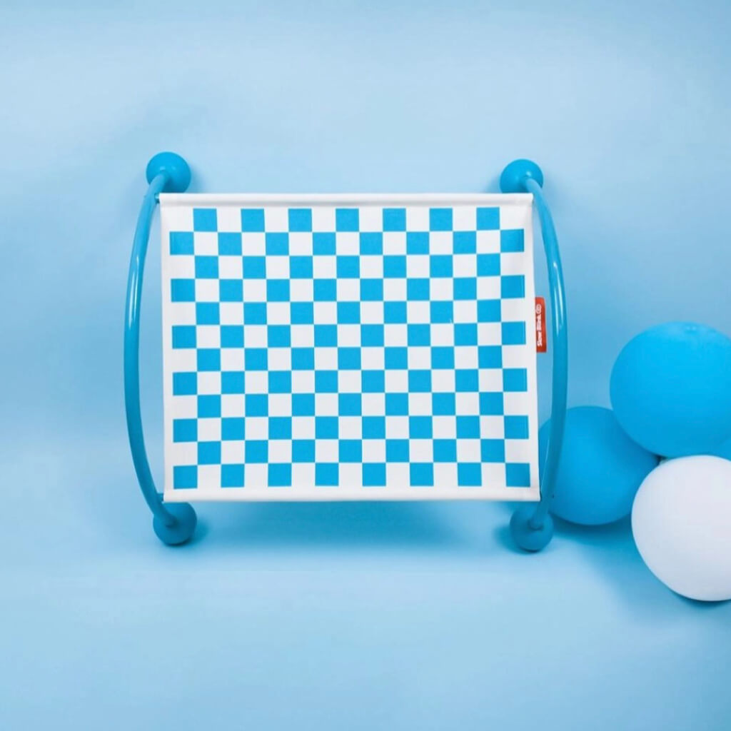 Blue cat hammock showcasing its checkerboard design and sturdy blue frame in a playful environment.