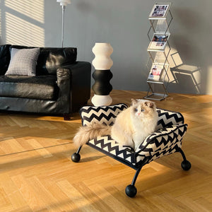 A fluffy Ragdoll cat enjoying a chic pet lounger, blending seamlessly into a modern home aesthetic.