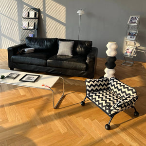 A stylish black-and-white chevron pet bed placed in a contemporary living space, adding a touch of Memphis-inspired design.