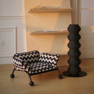 A cozy monochrome pet lounger in a sunlit minimalist home setting, perfect for all-season comfort.