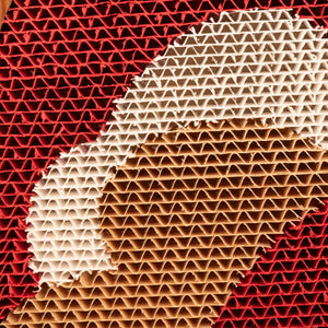 Close-up of the red, white, and beige wave pattern on the Hand-Crafted Paper Art Cat Scratcher.