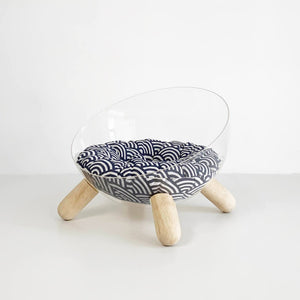 Blue patterned cushion inside acrylic cat bed with wood legs – Japanese-inspired design