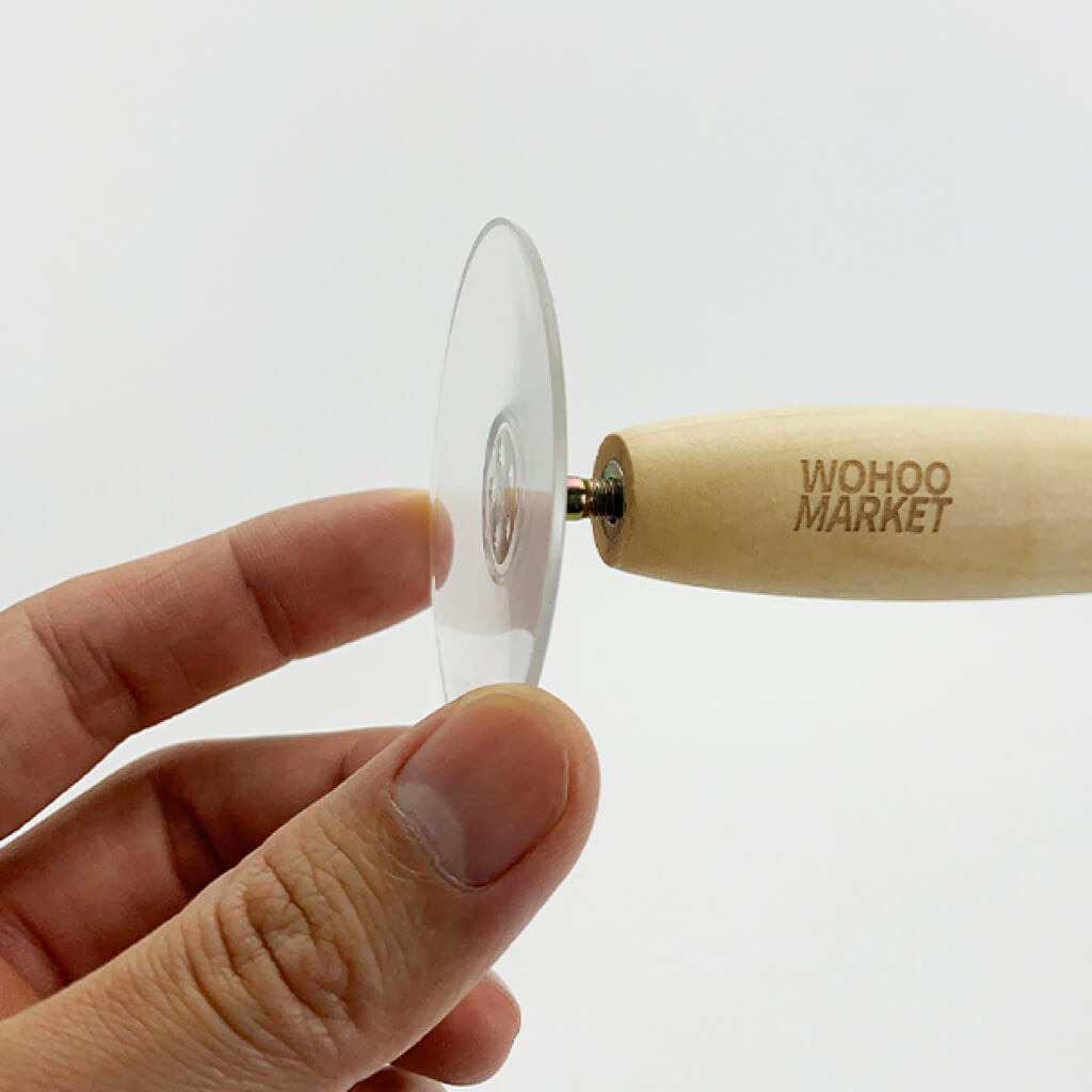 Close-up of a wooden handle with suction cup attachment for the interactive cat wand.