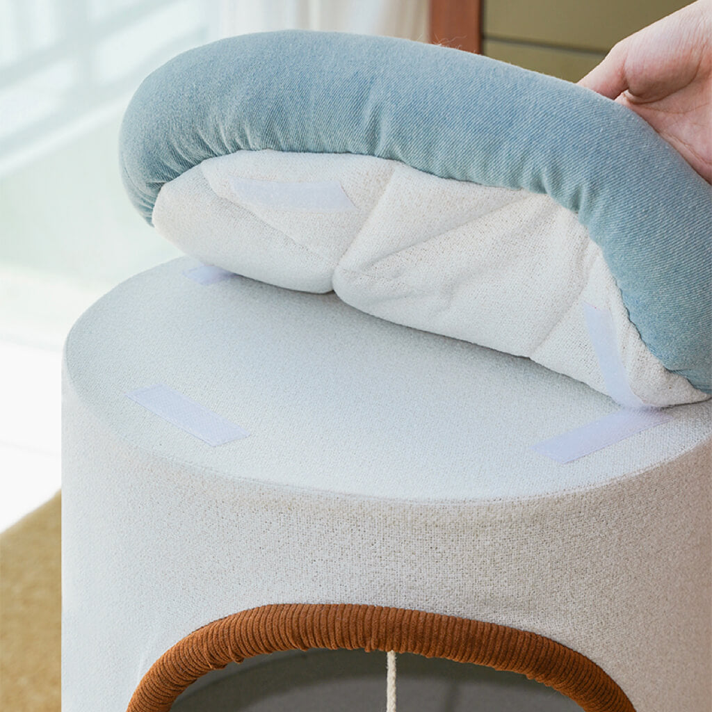 Close-up of removable denim blue bolster cushion on top of cat tower, showing Velcro attachment.