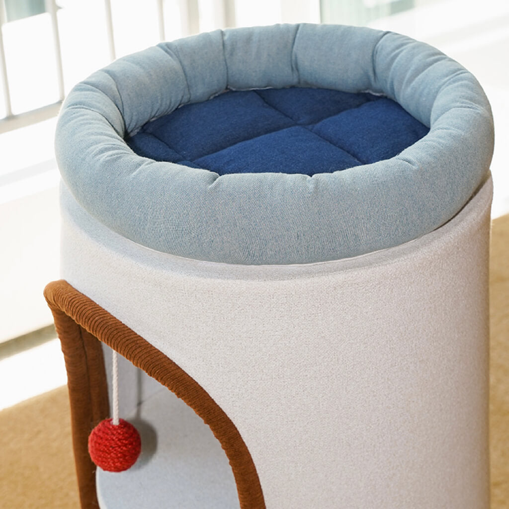 Bird’s eye view of blue and indigo denim cushion on round cat perch for cats.
