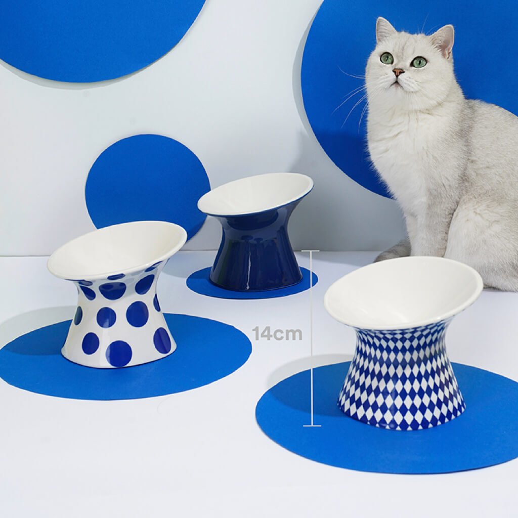 Three different ZEZE Elevated Ceramic Bowls in a minimalist setup with a cat.