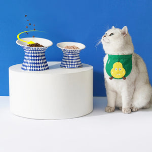 Cat next to ZEZE Elevated Ceramic Bowls - Blue Rhombus and Blue Polka Dots, filled with dry and wet food.