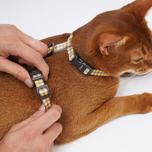 Adjustable strap detail on ZEZE checkered pet harness shown on a relaxed cat.