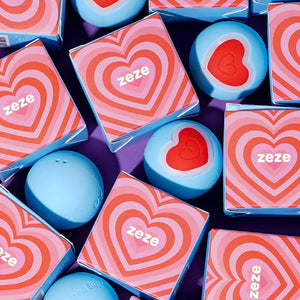 Multiple Zeze heart-packaged smart cat toy balls arranged together.