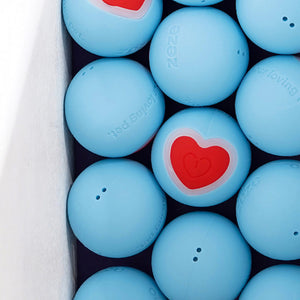Box filled with blue smart cat toy balls featuring red heart designs.